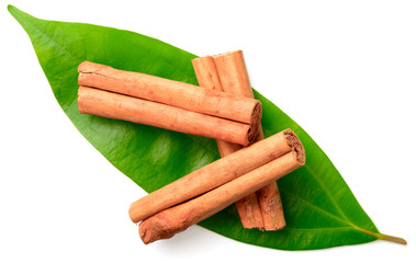 cinnamon sticks with fresh leaves isolatd on the white background, top view