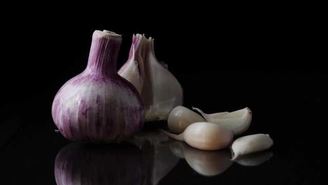 Delicious beautiful garlic on black background. Frame. Concept of a healthy lifestyle