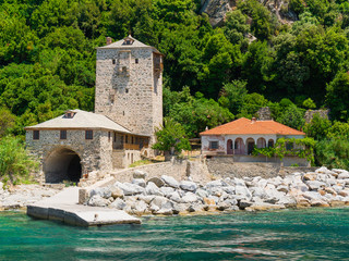 monastery buildings pier on shore of the Aegean Sea