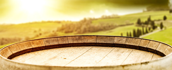 Wine photo of barrel and Tuscany landscape 