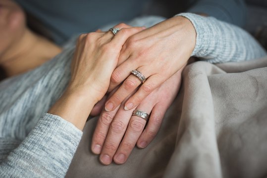 Close up of couple holding hands indoors