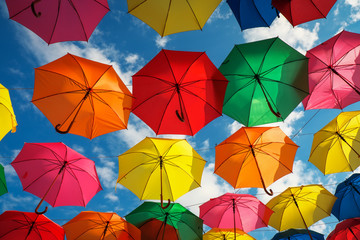 Lots of colorful umbrellas in the sky. City decoration