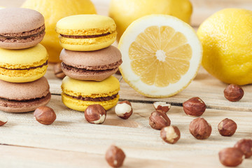Yellow and brown french macarons with lemon and hazelnuts