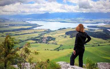 woman and liptov panorama on liptovska mara water lake reservoir and low tatras