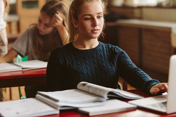 Student using laptop for studies in class