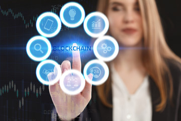 The concept of business, technology, the Internet and the network. A young entrepreneur working on a virtual screen of the future and sees the inscription: blockchain