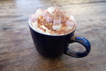 Hot chocolate drink with marshmallows in blue mug