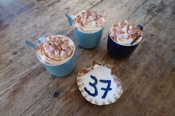 Three hot chocolate drinks with table number