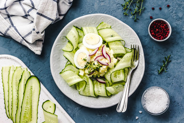 Healthy light avocado, eggs and  sliced cucumber salad.Top view, space for text.