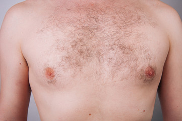 Chest of a man before trimming chest hair