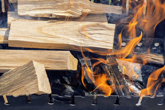 Wood logs burning in the grill