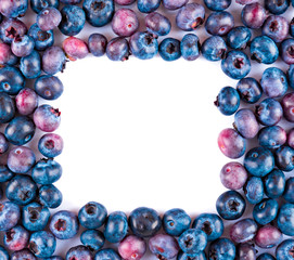 Fresh blueberries and leaves, berry frame isolated on white background, top view, frame
