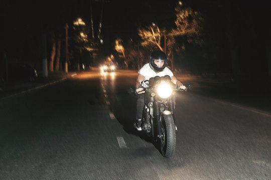  The Biker Is Riding A Motorcycle On The Highway At Night. Speed.