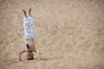 Boy practicing capoeira, handstand