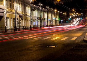 Fototapeta na wymiar Night view to the road in the city. Car light trails. Motion blur.
