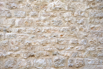 Light colour stone wall background texture.