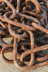 Old and rusty harbor chains.