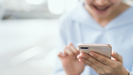 woman using smartphone on staircase in public areas, During leisure time. The concept of using the phone is essential in everyday life.