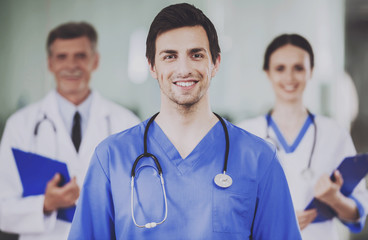 Male Doctor with Stethoscope in Blue Uniform.