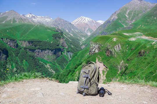 Traveler's travel bag in the background of a mountain landscape