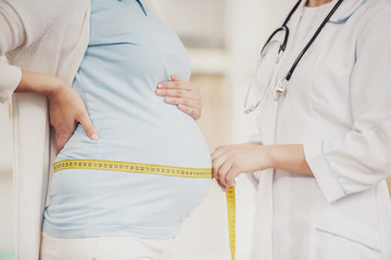 Pregnant Young Girl with Gynecologist in Hospital.