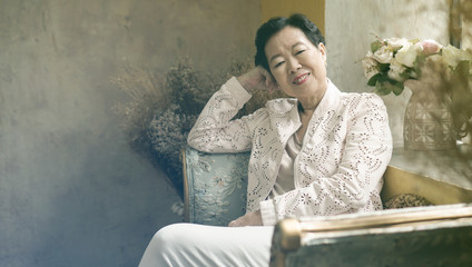 Asian elderly woman sit in beautiful luxury interior room tuscan vintage style
