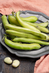 New harvest of healthy vegetables, green fresh raw big broad beans close up