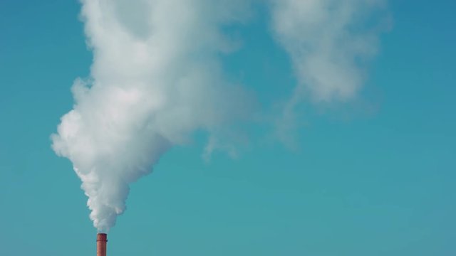 The pipe of the plant, amazing sky, produces clouds of smoke. Futa of smoke