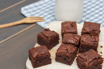 homemade cake chocolate brownies and milk on wooden table