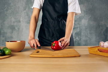 woman cutting vegetables in kitchen