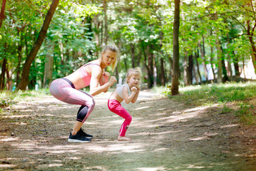 Boxing pose, ready to fight. Mother and daughter exercise together in park. Sport, Family, Healthy...