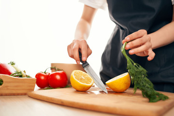 woman cutting vegetables in kitchen