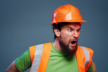 a builder in a helmet shouts