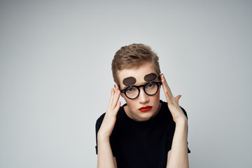woman in glasses on a gray background