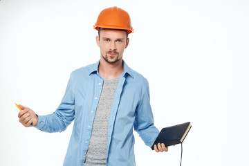 architect in an orange helmet with documents