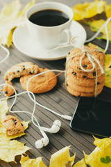 Arrangement of coffee and cookies with smartphone