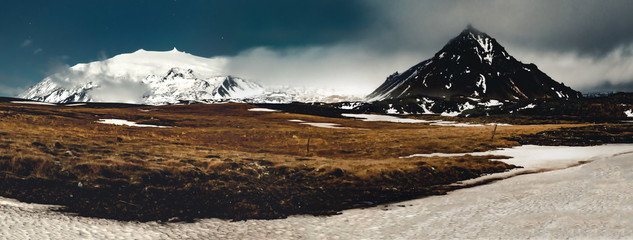 Panorama Image Night View snaefellsnesjokull Iceland with grass and blue sky stars with clouds and...