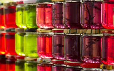 homemade tincture on honey multicolored in glass jars