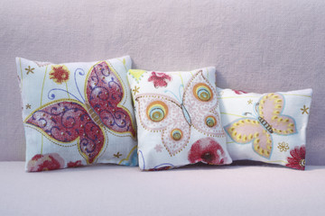 Three pillows with butterflies