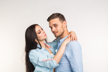 Young love couple hugging on white background