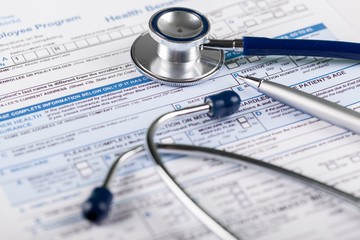 Stethoscope on Health Insurance Document / Medical Form
