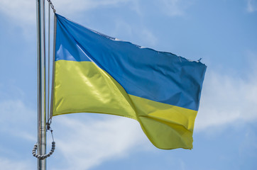 Ukrainian flag against the blue sky