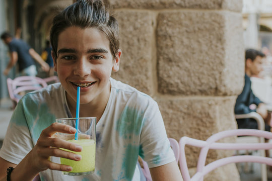 young man drinking soda on the street
