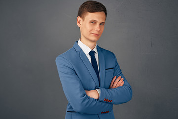 successful business man in suit on gray background