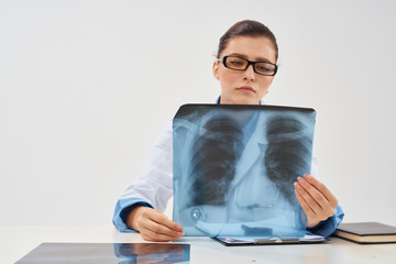 doctor serious looking at x-ray