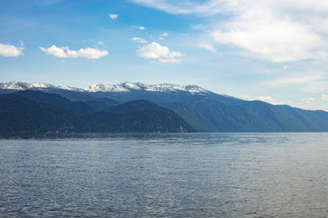 Magnificent nature, mountains with snow of Altai on Lake Teletskoye, Russia, Siberia