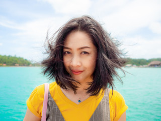 Woman portrait photo in windy beach.