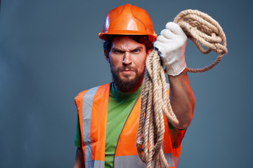 builder in helmet in hand rope