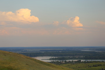 Panorama of a beautiful hill landscape, lake, river, forest, trees, and sky Russia. Life in the...