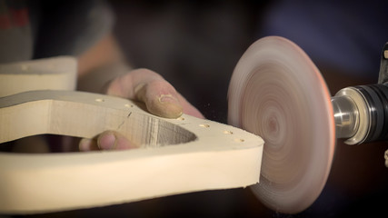 Fototapeta premium A large plan, hands of an artisan working on a wooden part